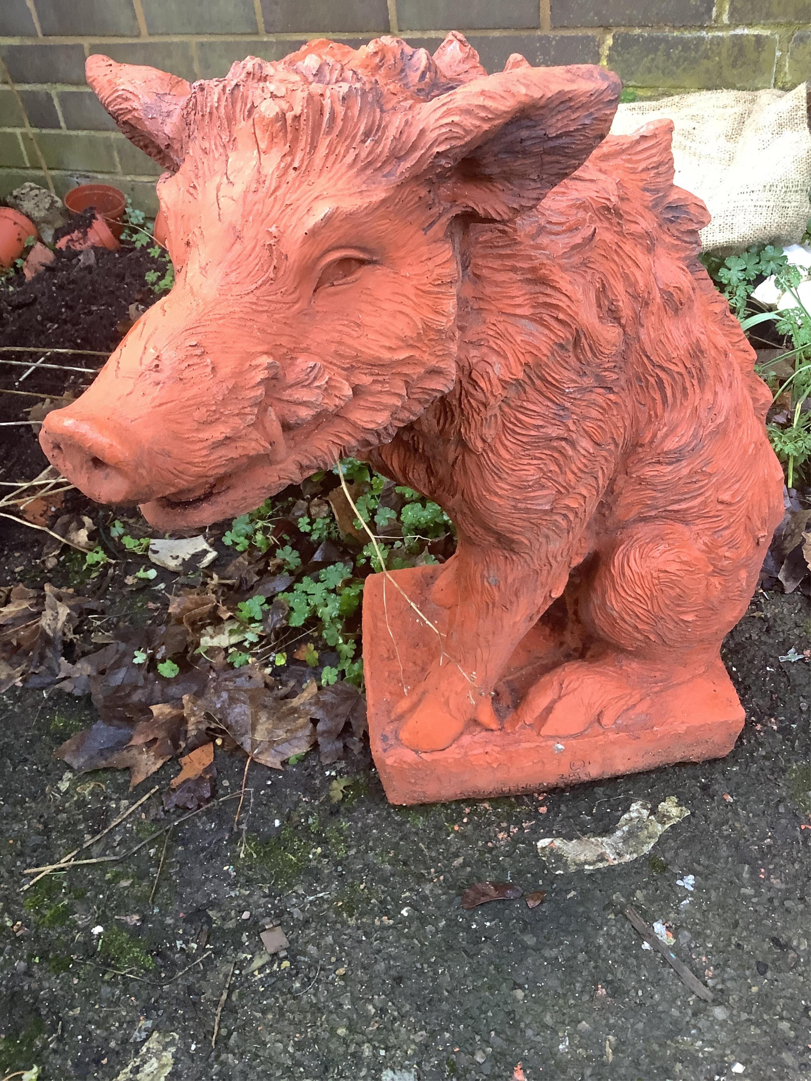 A pair of terracotta boars. Condition